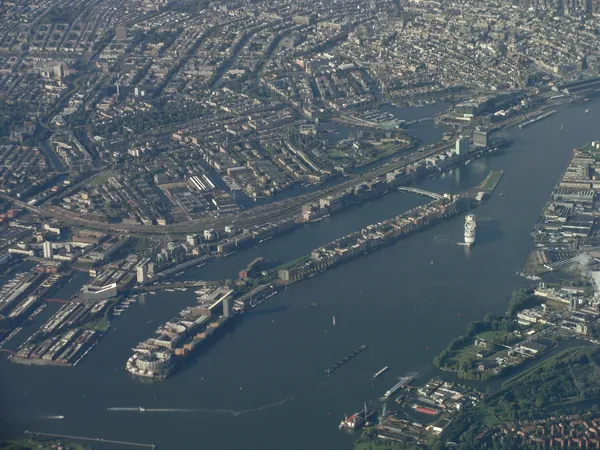 Amsterdam, with a departing cruise ship on the IJ.