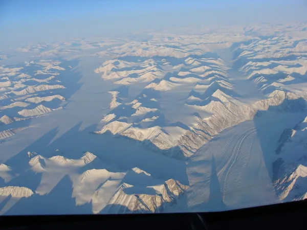 Mighty snow-covered peaks casting equally impressive shadows: Greenland en route to Vancouver.