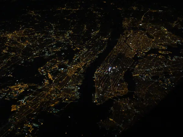 Manhattan, Times Square burning brightest.
