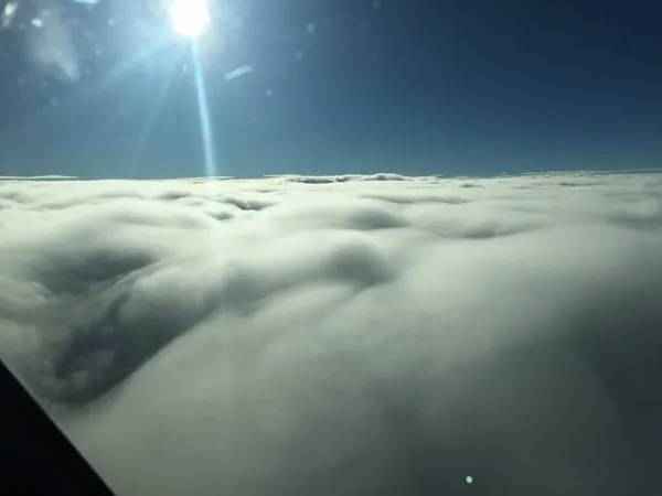 Surfing the clouds for a while, then slowly diving into them during the descent.